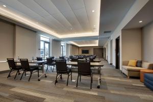 a conference room with tables and chairs and a couch at Hyatt House Oak Brook in Oak Brook +48 photos