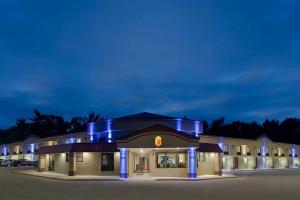 a hotel at night with blue lights at Super 8 by Wyndham West Greenwich/Providence in West Greenwich