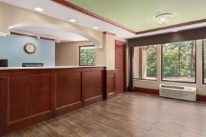 an empty waiting room with a waiting counter and windows at Super 8 by Wyndham West Greenwich/Providence in West Greenwich