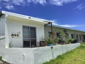 a white building with a fence in front of it at Shimaotoya in Iriomote
