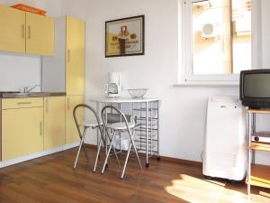 a kitchen with a table and chairs in a room at Apartment Chantal-3 by Interhome in Rabac