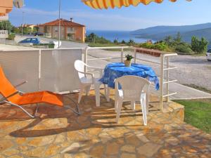 a table and chairs sitting on a patio at Apartment Chantal-3 by Interhome in Rabac