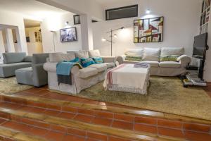 a living room with couches and a table at Made iN2 Creative Guest House in Montargil