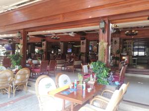 a restaurant with a wooden table and chairs and a tables and chairs at Havana Apart Hotel in Alanya