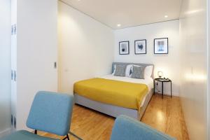 A bed or beds in a room at HM - Sta. Catarina Charming Apartment