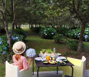 a young girl sitting at a table with food on it at Furnas Lake Forest Living in Furnas