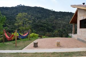 a patio with flags and a mountain in the background at Chalés Boa Vista in Gonçalves