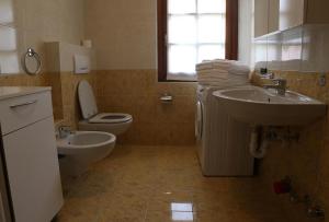 a bathroom with a sink and a toilet at Residence Lucia in Bormio