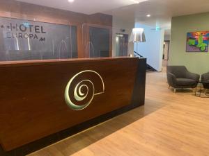 a hotel lobby with a reception desk with a spiral on it at Hotel Europa Art Caserta in Caserta