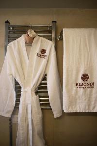 a robe and towels on a rack in a bathroom at Rimondi Residences Rethymno in Rethymno Town