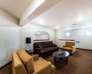 a living room with a couch and a table at Sleep Inn & Suites Guthrie - Edmond North in Guthrie