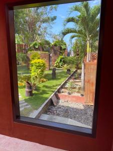 a view of a garden through a window at Villa Anjing 2 in Nusa Dua