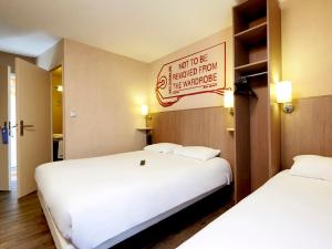 Postel nebo postele na pokoji v ubytování Brit Hotel Essentiel Cholet