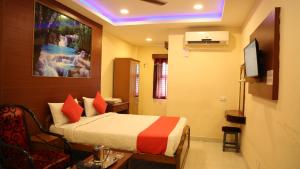 a hotel room with a bed in a room at Kumaran Millenium Residency in Vellore