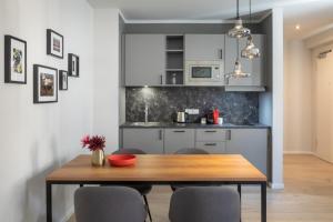 a kitchen with a wooden table and chairs at Brera Leipzig in Leipzig