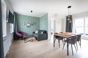 a dining room and living room with a table and chairs at Brera Serviced Apartments Leipzig in Leipzig