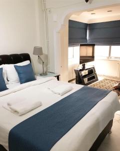 a bedroom with a large bed with blue and white sheets at My Kent Hotel in Istanbul
