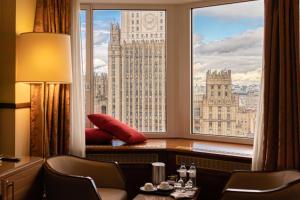 a room with a large window with a view of big ben at Golden Ring Hotel in Moscow