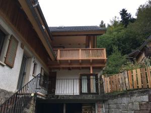 a house with a balcony and a fence at Ferienwohnung SichtWeiten in Seebach
