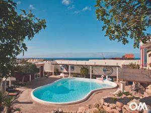 a swimming pool with a view of the ocean at Gartenappartement - Tierra - Surf & Yoga Villa in La Pared