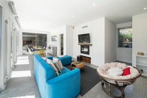 a living room with a blue couch and chairs at Casa da Maloeira by An Island Apart in Fajã da Ovelha