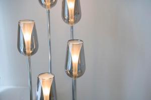 a chandelier with six lights on a wall at ChocoLets - The Foss Suite in York