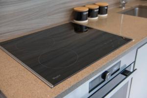 a kitchen counter with a black stove top oven at ChocoLets - The Foss Suite in York