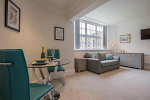 a living room with a couch and a table at ChocoLets - The Foss Suite in York