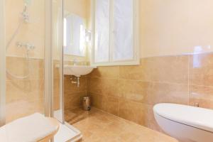 a bathroom with a shower and a sink and a toilet at Hotel Bellevue Saint-Lazare in Paris