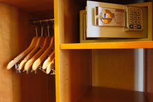 a closet with a wooden cabinet with a microwave at Hotel Bellevue Saint-Lazare in Paris
