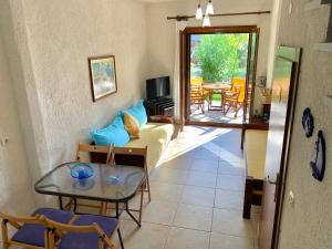 a living room with a couch and a table at Stella's Maisonette in Siviri