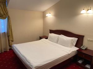 Кровать или кровати в номере Отель Купеческий