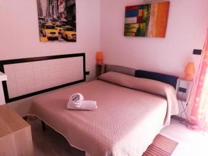 a bedroom with a bed, a desk, and a painting on the wall at B&B Alghero Republic in Alghero