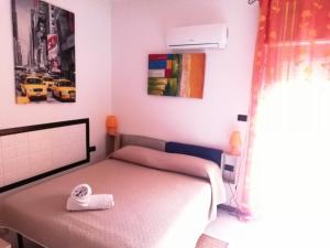 a bedroom with a bed and a lamp at B&B Alghero Republic in Alghero