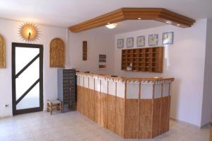 a kitchen with a bar in a room with a door at FAMILY HOTEL SAINT PETER in Saints Constantine and Helena