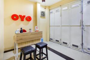 a dressing room with two stools and a closet at Hotel O Sofia Homestay Syariah in Bogor