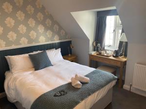 a bedroom with a bed and a dresser at Three Bishops Inn in Newport