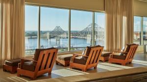 a room with three chairs and a view of a bridge at Four Seasons St. Louis in Saint Louis
