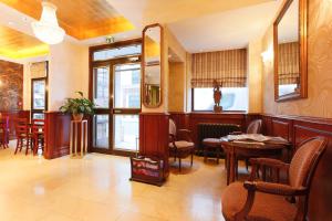 a dining room with tables and chairs in a restaurant at Hotel Bellevue Saint-Lazare in Paris