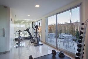 a gym with two exercise bikes and a large window at Departamentos Farley in Tigre