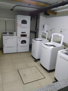 a laundry room with several washers and dryers in it at Departamentos Farley in Tigre +23 photos