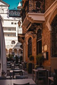 un patio vacío con mesas y sillas en un edificio en Hotel Duomo Cremona, en Cremona