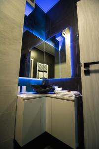 a bathroom with a sink and a mirror at Gente Apartments in Cluj-Napoca