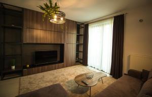 a living room with a couch and a table at Gente Apartments in Cluj-Napoca