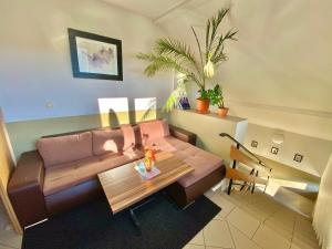 a living room with a couch and a table at Penzión DOMES in Čadca
