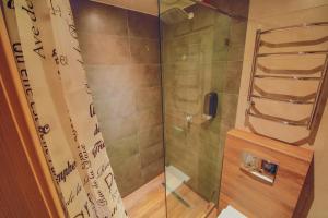 a shower with a glass door in a bathroom at Sport Hotel 1 in Cherkasy +39 photos