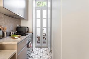 a kitchen with a door leading into a kitchen with a counter at FLH Vila Rosário Cosy Flat I in Lisbon