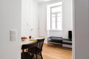 a kitchen and dining room with a table and chairs at FLH Vila Rosário Cosy Flat I in Lisbon