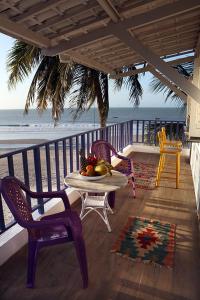 a table and chairs on a balcony with the ocean at Saint Germain Kite Residence in Icaraí