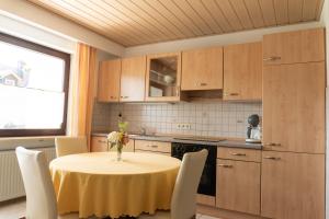 a kitchen with a table with a vase of flowers on it at Ferienwohnung Andrea in Riedenburg